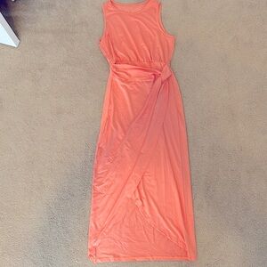 Sleeveless peach colored dress.
